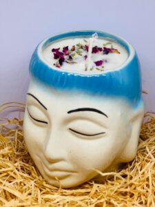 Focus candle in Buddha faced ceramic jar.